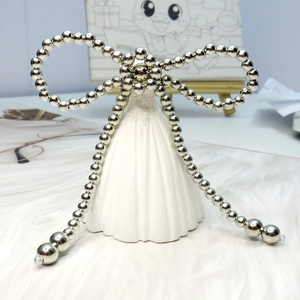 Close-up of silver pearl beaded bow accessory for DIY clothing and headwear decoration