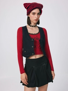 Detail shot of a punk style red and black striped cat ear beanie with heart choker