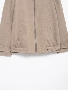 Detailed macro of taupe wool-like pilot jacket with metal zipper and adjustable hem buckle