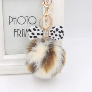 Leopard print faux fur pompom keychain with polka dot bow and crystal details