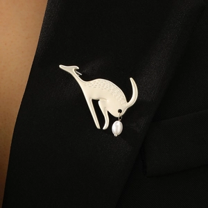 Artistic silver stag brooch with white pearl drop on black blazer lapel for women