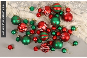 Set of 44 red and green Christmas ornaments with snowflakes and stripes on grey surface