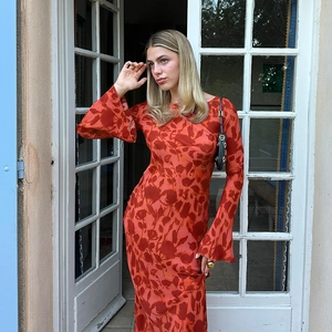 Detail of elegant floral maxi dress with flared sleeves and vintage print pattern