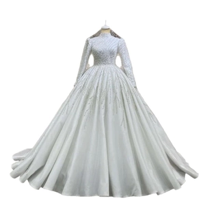 Luxurious white ball gown bridal dress with long sleeves, high neck and heavy beadwork