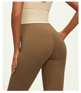Macro view of high-waist yoga flare pants showing peach-lift curved back seams