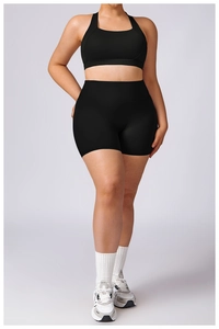 Detail of high-stretch plus size black yoga set with sports bra and biker shorts