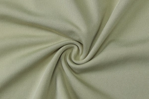 Macro detail of soft sage green ribbed knit fabric showing fine texture and elasticity