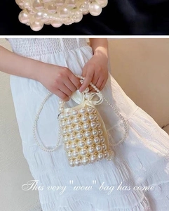 Macro detail of handmade pearl bucket bag with gold beads and satin drawstring liner