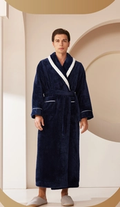 Detail of navy blue flannel robe featuring white trim and textured diamond grid fabric