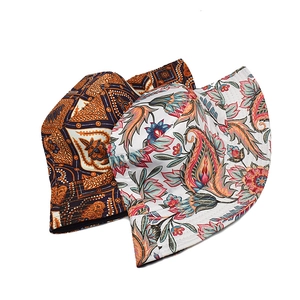 Detailed close-up of double-sided bucket hats with paisley and floral ethnic patterns