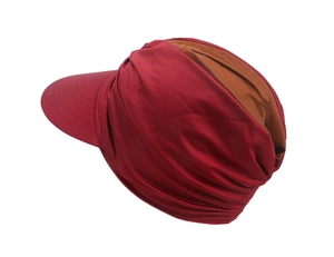 Detailed side view of a burgundy and brown sun hat with a wide brim and pleated texture