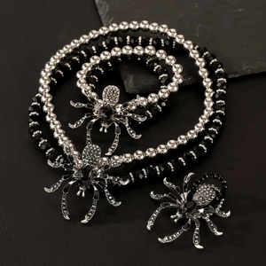Detailed view of gothic spider necklace with black gems and silver bead chain
