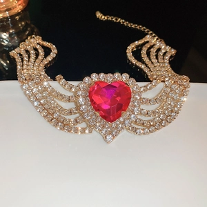 Close-up of golden multi-row rhinestone choker with a large magenta heart gemstone