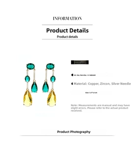 Detail of long teardrop earrings with green and yellow zircons and golden copper finish
