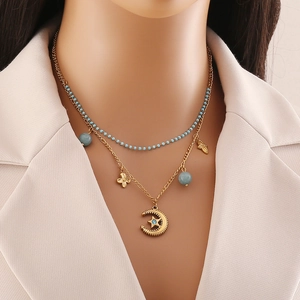 Double-layered gold chain necklace featuring blue beads and celestial star-moon pendant