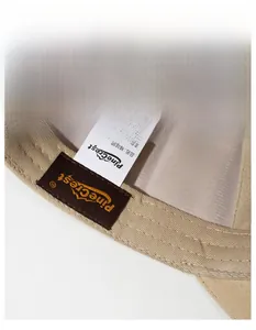Close-up of beige baseball cap interior with cotton sweatband and embroidered logo detail