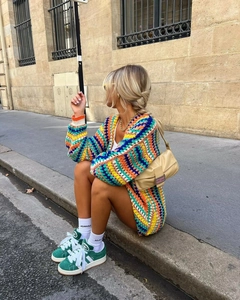 Detailed view of colorful handmade crochet cardigan with vibrant bohemian stripes