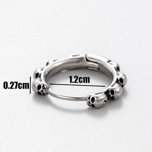 Macro detail of men's skull huggie earring showing 1.2cm diameter and 0.27cm thickness