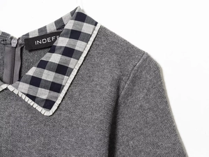Detail view of grey knit dress with black and white plaid Peter Pan collar and back zipper