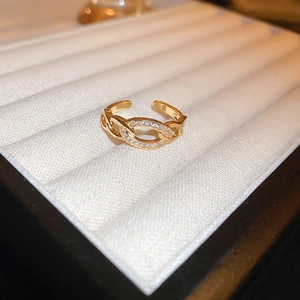Macro detail of gold plated dragon ring with white zircon stones on jewelry box display