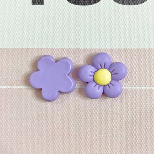 Close-up of matte purple five-petal resin flowers with smooth surface for DIY crafts