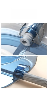 Detail of transparent hair basin drainage system with a white plug and gray flexible hose
