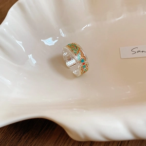 Detailed macro view of silver open ring with colorful enamel ethnic patterns on shell