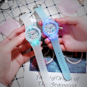 Close-up of sky blue and white LED glowing watches with frosted silicone straps