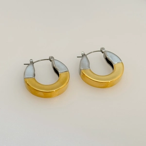 Macro detail of two-tone 18k gold and silver plated thick C hoop earrings