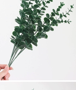 Close-up of green artificial eucalyptus leaves texture and branch details