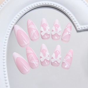 French style stiletto press-on nails with pink base, white bows and delicate pearls