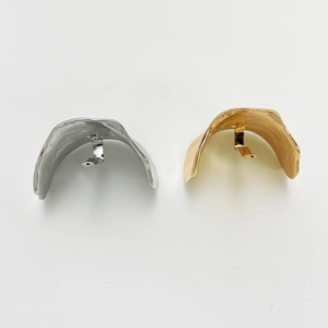 Detailed view of silver and gold curved alloy hair hook clips for low ponytail styles