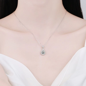 Elegant S925 sterling silver necklace with a teardrop moissanite pendant on a model