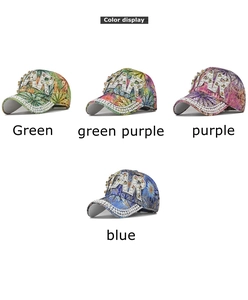 Detail view of colorful floral baseball caps with rhinestones and large pearl AR initials