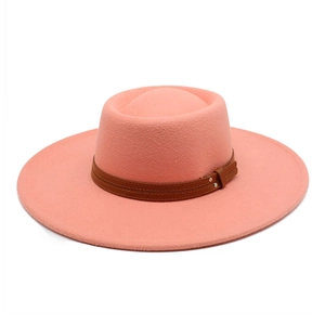 Detail view of pink wool fedora with brown leather bands and metallic rivet accents
