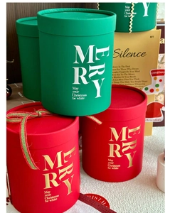 Detail of red and green cylindrical Christmas gift boxes with Merry Christmas lettering