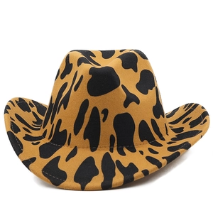 Detailed view of western cow print felt hat with thick fabric and curved brim texture