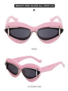 Close-up of bright pink Y2K cat-eye sunglasses with grey lenses and silver metal details