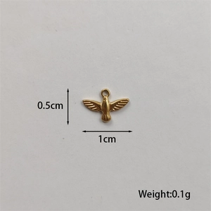 Macro shot of a tiny gold-plated bird pendant showing 1cm width and 0.1g weight details