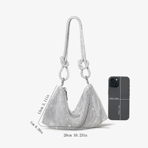 Detailed size chart of silver rhinestone handbag with mobile phone for scale