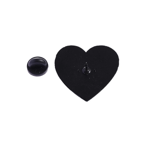 Close-up of heart-shaped badge back with black rubber pin clutch on white background