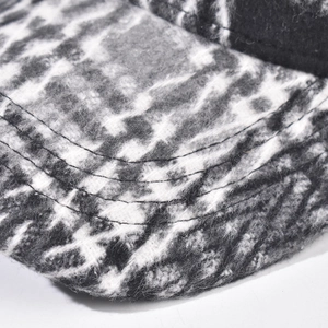Macro detail of plaid baseball cap brim with precise stitching and marble fabric texture