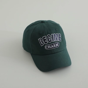 Detailed close-up of dark green cotton baseball cap with BECIME CHARM letter embroidery