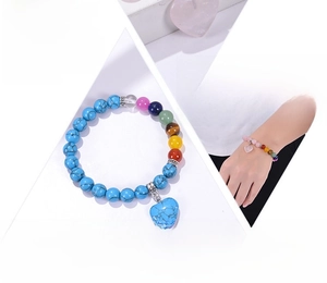 Detail of 6mm natural stone beaded bracelet with heart pendant and chakra beads for yoga