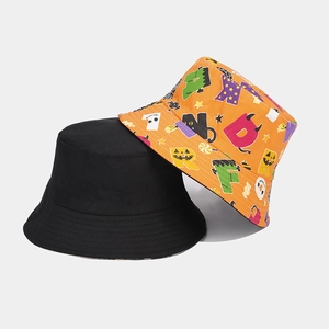 Close-up of black and orange Halloween bucket hats with cartoon pumpkin and ghost patterns