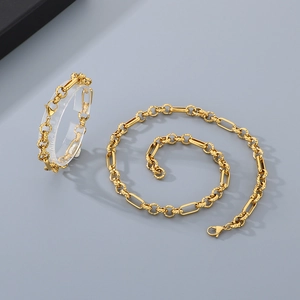 Detailed shot of golden stainless steel chain set with engraved links and lobster clasp