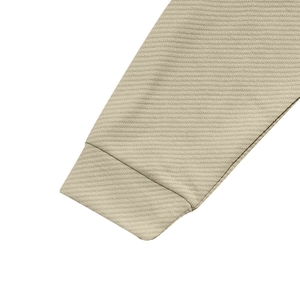 Detailed macro shot of the twill fabric texture and sleeve cuff seam of the khaki jacket