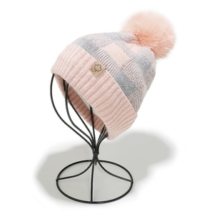 Close-up of pink and grey checkered knit beanie with a faux fur pompom and maple leaf patch