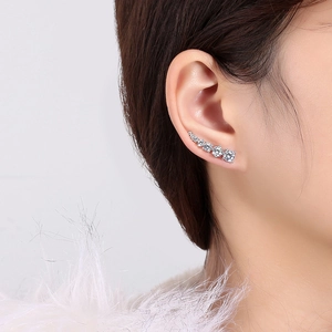 Macro view of silver crawler earrings featuring five graduated cubic zirconia stones