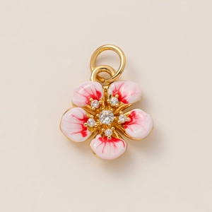 Macro shot of 18K gold plated flower pendant with pink petals and clear zircon centers